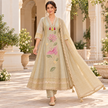 Golden cream embroidered A-line suit for women with pink bird and floral motifs, matching pants and embellished dupatta