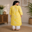 Yellow Chikankari kurta set for women with white floral print and lace palazzo pants