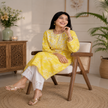 Yellow Chikankari kurta set for women with white floral print and lace palazzo pants